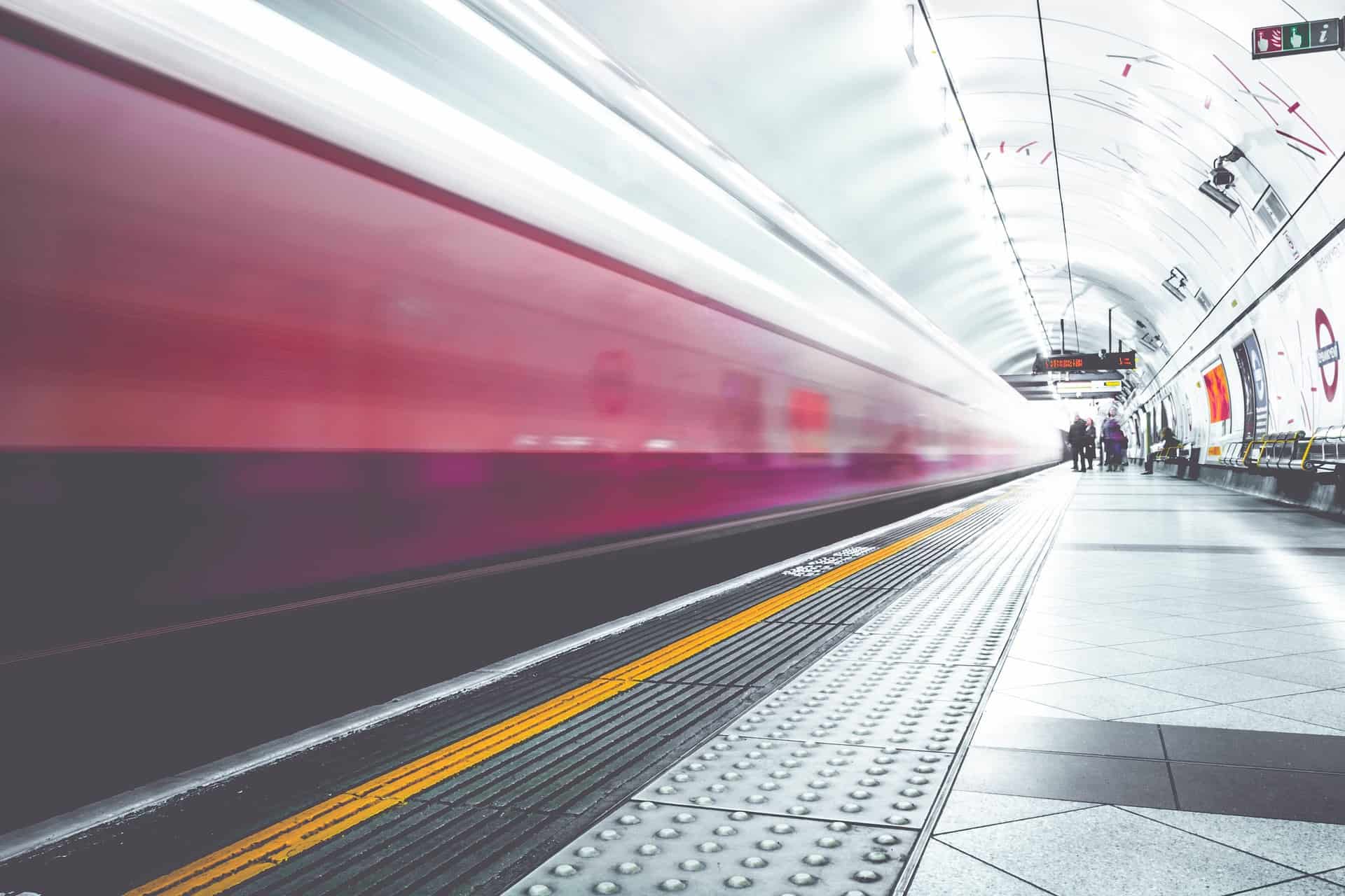 Subway train speeding through a station platform