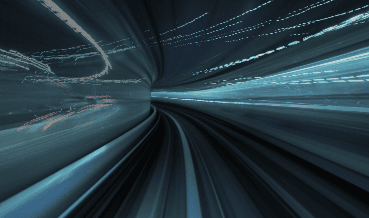 Blurry image of a tunnel with colorful light streaks, creating a sense of speed and motion